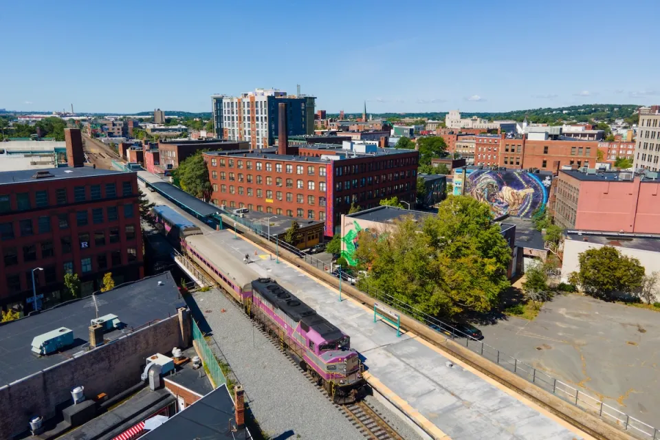 Aerial view of purple MBTA commuter train at station in Lynn, Massachusetts.